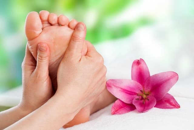 Reflexology massage focusing on pressure points in the feet.