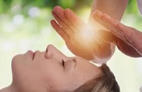 Reiki healing with gentle hand placements for energy balance.