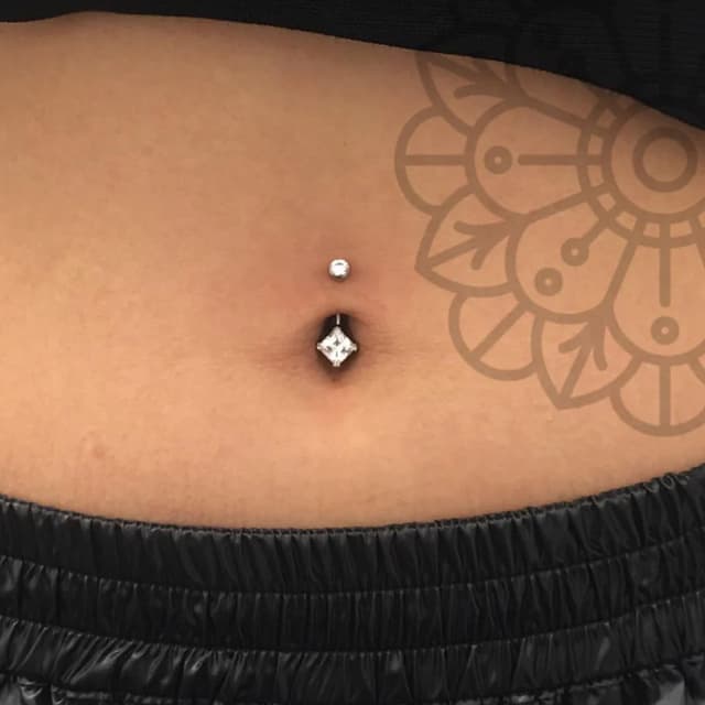 Belly button piercings with rings or studs.