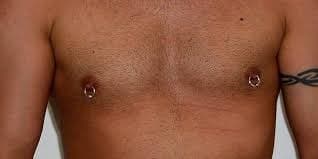 Nipple piercings with rings or barbells.