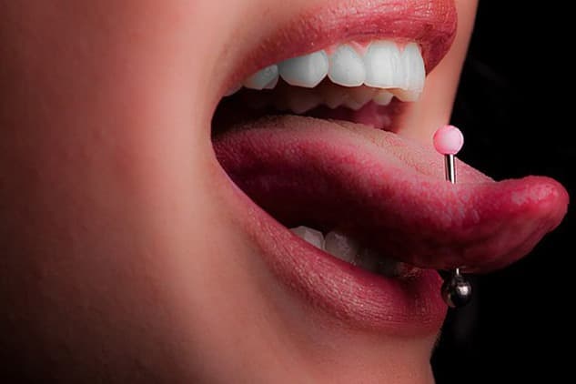 Tongue piercings with various styles of jewelry.