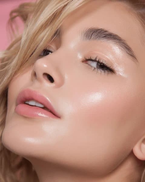 Dewy skin makeup with a glowing finish.