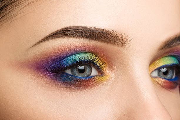 Watercolor-inspired eyeshadow with soft, blended colors.